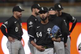 Chicago White Sox relief pitcher Deivi García (64) walks back to the dugout after a pitching change during the sixth inning of the team's baseball game against the Minnesota Twins, Wednesday, April 24, 2024, in Minneapolis. (AP Photo/Abbie Parr)