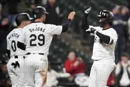 Chicago White Sox's Martín Maldonado, right, celebrates with teammates Danny Mendick (0) and Paul DeJong (29) after his three-run home run off Tampa Bay Rays starting pitcher Zach Eflin during the sixth inning of a baseball game Friday, April 26, 2024, in Chicago. (AP Photo/Charles Rex Arbogast)