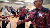 Arlington Squares Square Dancing Club Co-President Denise Hopkins, center in plaid shirt, and her husband, Charles Hopkins, right in a matching plaid shirt, dance during the club’s 75th anniversary celebration last week in Palatine.