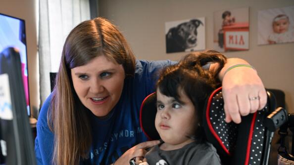 Jeanna Polacek assists her daughter, Mia, at their family’s home in Round Lake. Mia has Edwards Syndrome/Trisomy 18, which means she has an extra copy of chromosome 18.