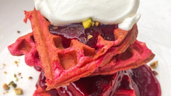 These Beet Waffles are served with raspberry-rose jam, lemon whipped cream and toasted pistachios.