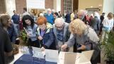 Parishioners at S. James Parish in Arlington Heights look through items Sunday that were pulled from a time capsule from the 1950s that was found in the church during a renovation project. Parishioners were encouraged after Mass to leave notes about the church to be placed back in the time capsule and opened in 75 years.