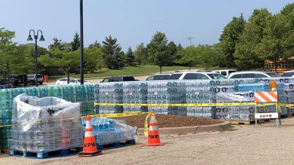 Cases of bottled water sat on pallets at the Hawthorn Woods Aquatic Center last July after an Aqua Illinois water system failed, rendering tap water for hundreds of area customers unsafe to drink. Legislation that would require utility companies to notify fire departments when water supplies are disrupted has passed the state House.