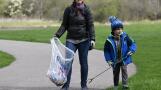 Terese Hajduk and her son, Evan, 4, help clean up during an Earth Day event Saturday at Busse Woods in Elk Grove Village.