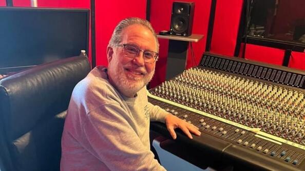 Richard Peck at his sound mixing board in his Geneva studio. Peck has provided sound mixing boards and stage equipment for musicians and other acts since 1976.