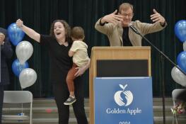 Plainfield Elementary School Principal Lisa Carlos, center, celebrates Monday with her students and staff at the Des Plaines school as she is introduced as winner of the Golden Apple award for Excellence in Leadership. Announcing the award is, at right, Alan Mather, president of the Golden Apple Foundation.