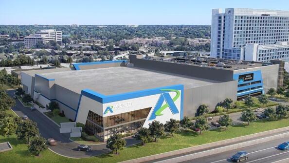 A rendering depicts the forthcoming Andretti Indoor Karting &amp; Games alongside a six-level parking deck with an electronic message board facing the Interstate 90 tollway on the west side of the Renaissance Schaumburg Hotel &amp; Convention Center.
