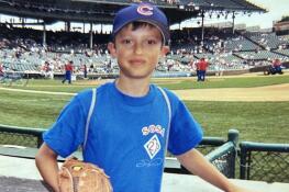 A young Collin Peterson touches the wall where his grandfather laid bricks for the original Wrigley field.  This portion of the wall does not exist anymore since the park was renovated and they moved the wall forward to accommodate more seats.