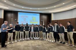 Palatine Mayor Jim Schwantz, far left, speaks to members of the Palatine High School boys basketball team, which was honored by the village council Monday for their 4th place finish in state.