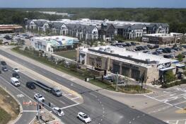 Mellody Farm retail/residential development in Vernon Hills, right, features a variety of shops and restaurants, as well as 260 apartments. A tax increment financing district created by the village as an incentive could end 14 years early because of the center’s success.