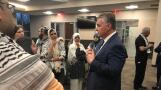 Palatine Village Manager Reid Ottesen speaks with supporters of a cease-fire in Gaza following Monday night's village council meeting.