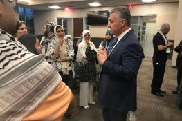 Palatine Village Manager Reid Ottesen speaks with supporters of a cease-fire in Gaza following Monday night's village council meeting.