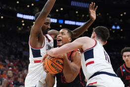 San Diego State forward Jaedon LeDee, center, is trapped between UConn forward Samson Johnson, left, and UConn forward Alex Karaban (11) during the second half of the Sweet Sixteen college basketball game in the men's NCAA Tournament, Thursday, March 28, 2024, in Boston. (AP Photo/Steven Senne)