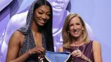 LSU's Angel Reese, left, poses for a photo with WNBA commissioner Cathy Engelbert after being selected seventh overall by the Chicago Sky during the first round of the WNBA basketball draft on Monday, April 15, 2024, in New York. (AP Photo/Adam Hunger)
