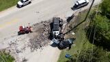 Debris from an overturned truck is cleared from the scene of a fatal crash Wednesday morning at Fairfield and Chardon Roads in Lake County near Wauconda.