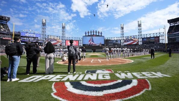 Two U.S. Army helicopters fly over Guaranteed Rate Field during the Chicago White Sox's home opener baseball game against the Detroit Tigers Thursday, March 28, 2024, in Chicago. (AP Photo/Charles Rex Arbogast)
