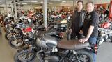 Geoff Mellinger, right, sold Motor Cycle Center in Villa Park to Johnny Scheff of Motoworks Chicago. They are standing here in the Villa Park showroom were they sell several European brands.