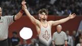 St. Charles East’s Ben Davino is declared the winner against Hononega’s Thomas Silva in the Class 3A 132-pound bout at the IHSA state individual boys wrestling championships at the University of Illinois on Saturday, Feb. 17, 2024. It was his fourth state championship.